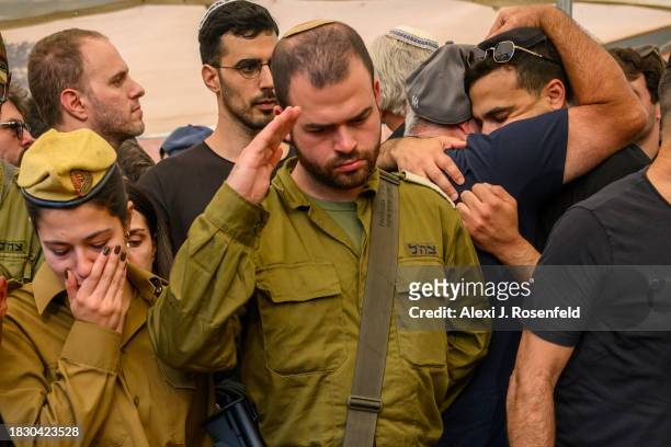 Mourners grieve for Col. Asaf Hamami, commander of Gaza Division's Southern Brigade, during his funeral at the Kiryat Shaul cemetery on December 04,...