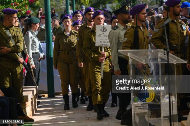 The casket and name placard of Col. Asaf Hamami, commander of Gaza Division's Southern Brigade, is carried into his funeral at the Kiryat Shaul...