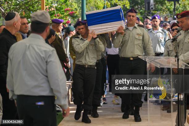 The casket of Col. Asaf Hamami, commander of Gaza Division's Southern Brigade, is carried into his funeral at the Kiryat Shaul cemetery on December...