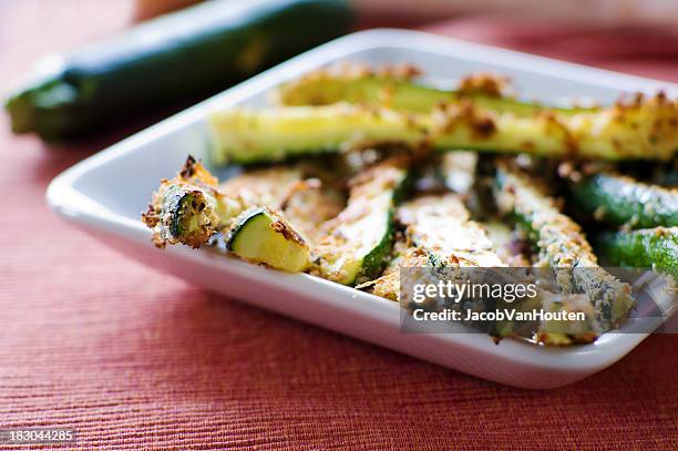 baked zucchini fried on a white square plate - courgette stock pictures, royalty-free photos & images