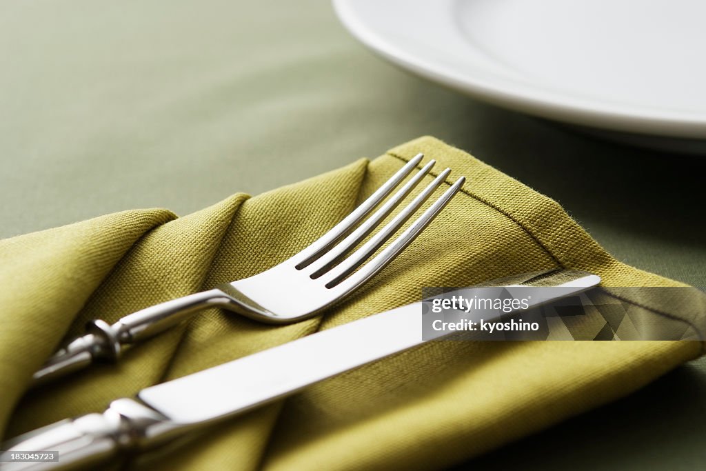 Close-up shot of green table setting with copy space