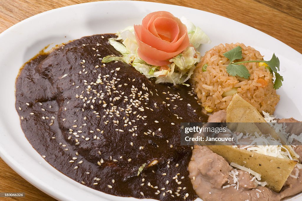 Enchiladas served with rice and beans