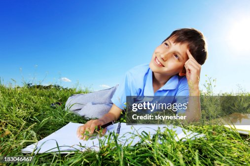 Writing Notebook Outside Young Boy Writing On A Notebook Outside High-Res Stock Photo - Getty Images