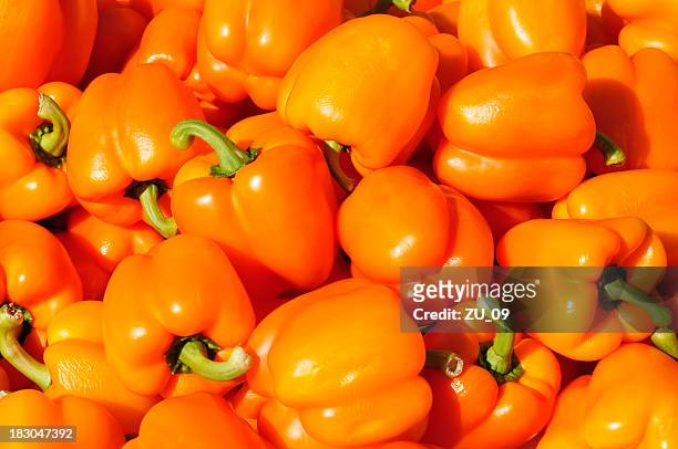 orange peppers at a street market - orange bell pepper stock pictures, royalty-free photos & images