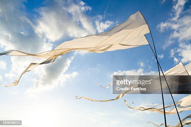 white flags against sun - buddhist flag stock pictures, royalty-free photos & images