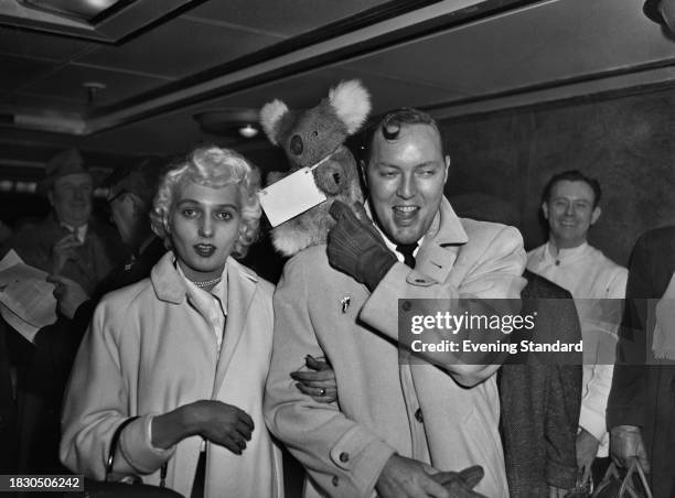 American rock'n'roll singer Bill Haley arriving at Southampton with wife Barbara and a Koala toy, February 5th 1957. Haley was travelling to London...
