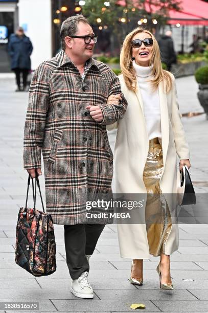 Alan Carr and Amanda Holden leave Global Studios together on December 7, 2023 in London, United Kingdom.