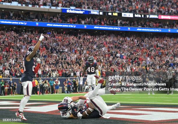 Houston Texans safety Jimmie Ward , bottom center, intercept a pass to Denver Broncos tight end Lucas Krull at the end of the game to stop a late...