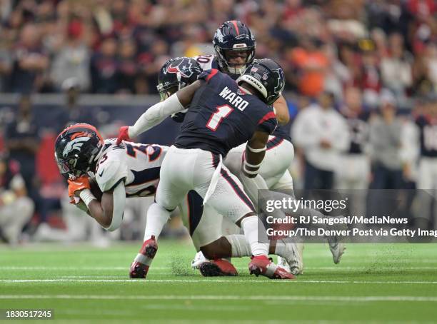 Denver Broncos running back Javonte Williams dives forward for a first down during the second half at NRG Stadium in Houston, Texas on December 3,...