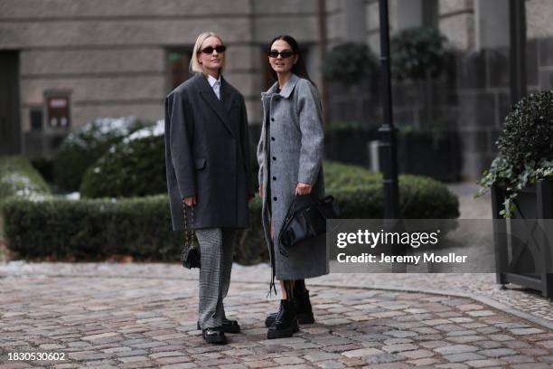 Marlies Pia Pfeifhofer seen wearing brown oval sunglasses, silver earrings, white cotton buttoned blouse / shirt, COS dark grey short oversized wool...