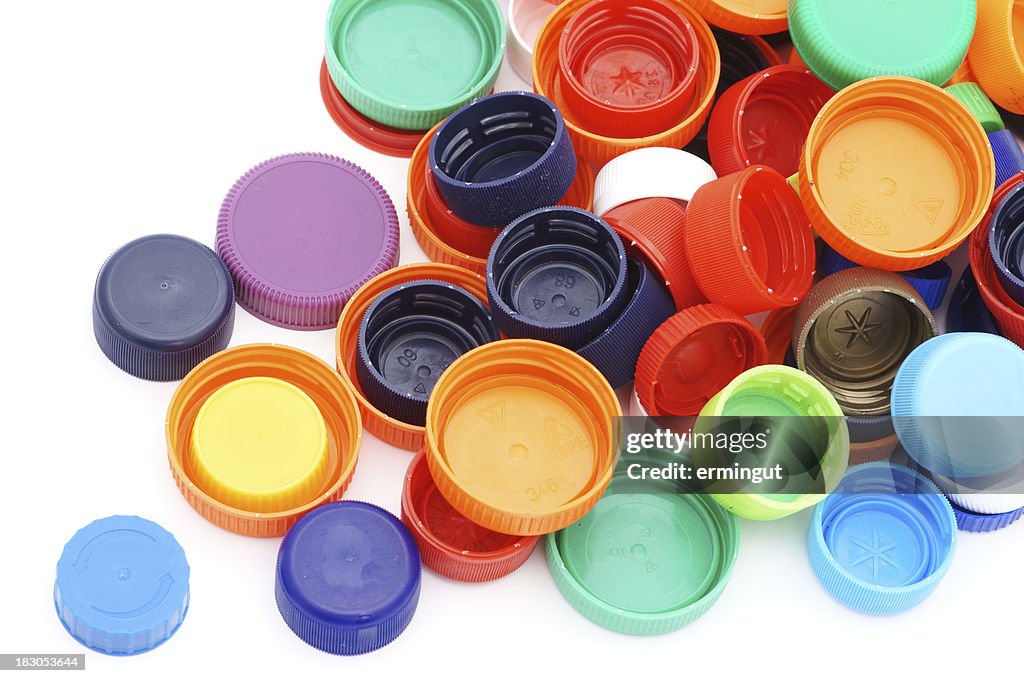 Scattered colorful plastic caps isolated in white