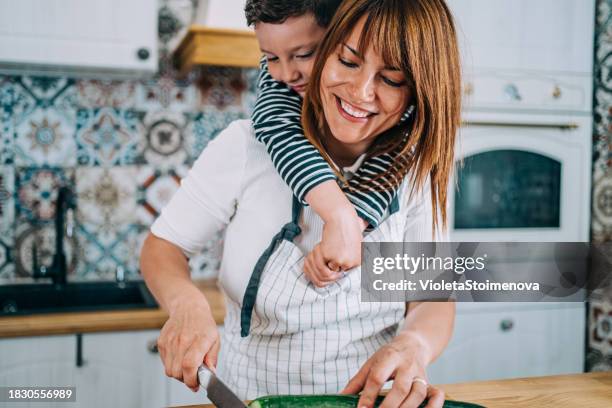mother and son cooking together in the kitchen. - chopped stock pictures, royalty-free photos & images