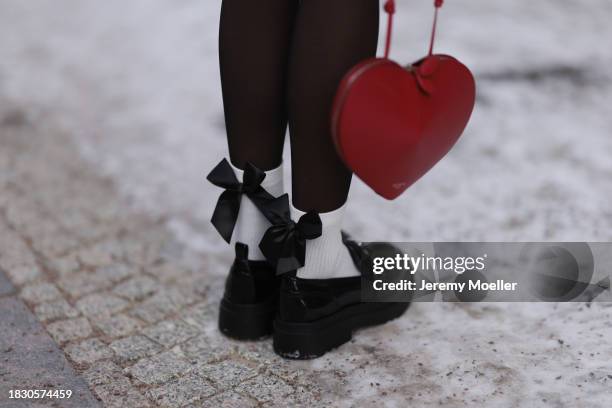 Celine Bethmann seen wearing Calzedonia black tights, Alaia red leather hearth shaped bag, white cotton socks with black ribbon details and Liu Jo...
