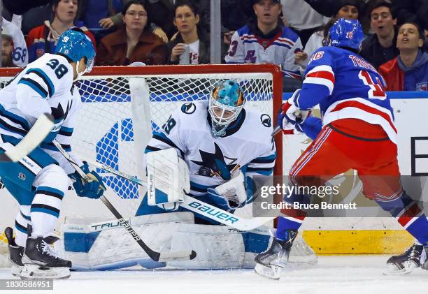 Mackenzie Blackwood of the San Jose Sharks takes a puck to the stomach against Vincent Trocheck of the New York Rangers at Madison Square Garden on...