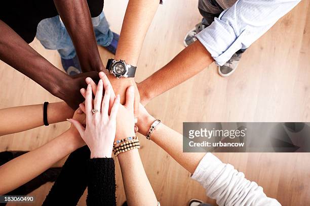 group with hands together - harmonie stockfoto's en -beelden