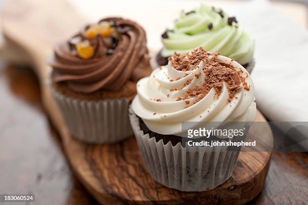 three cupcakes - cup cake stock pictures, royalty-free photos & images
