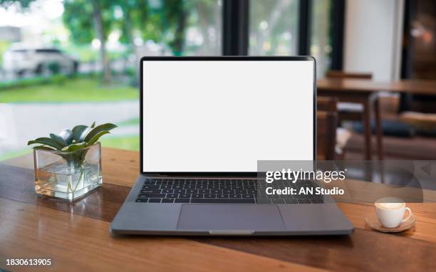 laptop computer blank screen on table in cafe background. laptop with blank screen on table of coffee shop blur background - coffee table front view stock pictures, royalty-free photos & images