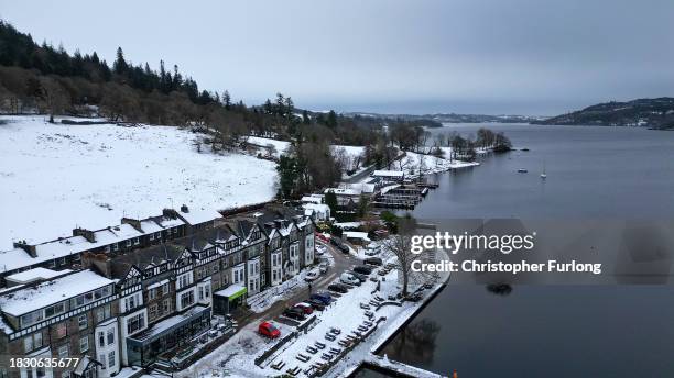 Recent snow, freezing temperatures and a heavy sky create a monochromatic scene over Lake Windermere and its sailing jettys atb Ambleside, Cumbria on...