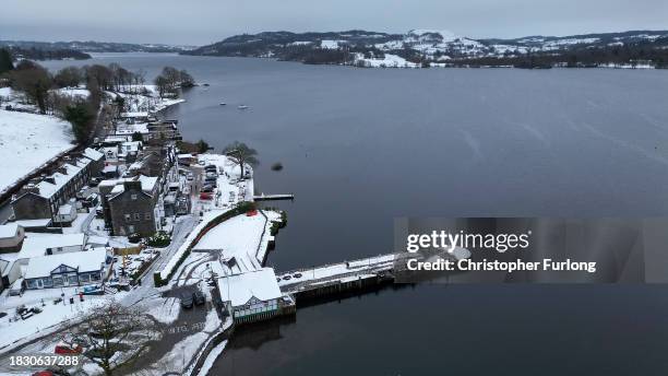 Recent snow, freezing temperatures and a heavy sky create a monochromatic scene over Lake Windermere and its sailing jettys atb Ambleside, Cumbria on...