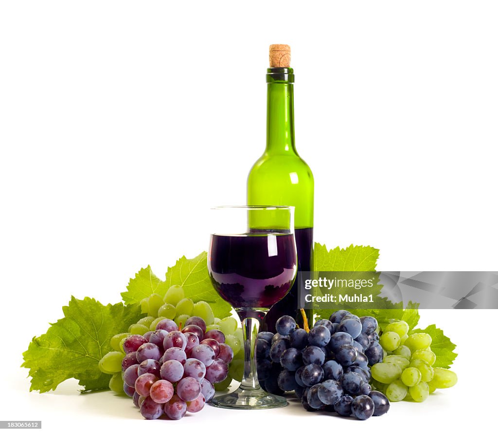 Grapes, a glass of wine and a bottle of wine composition