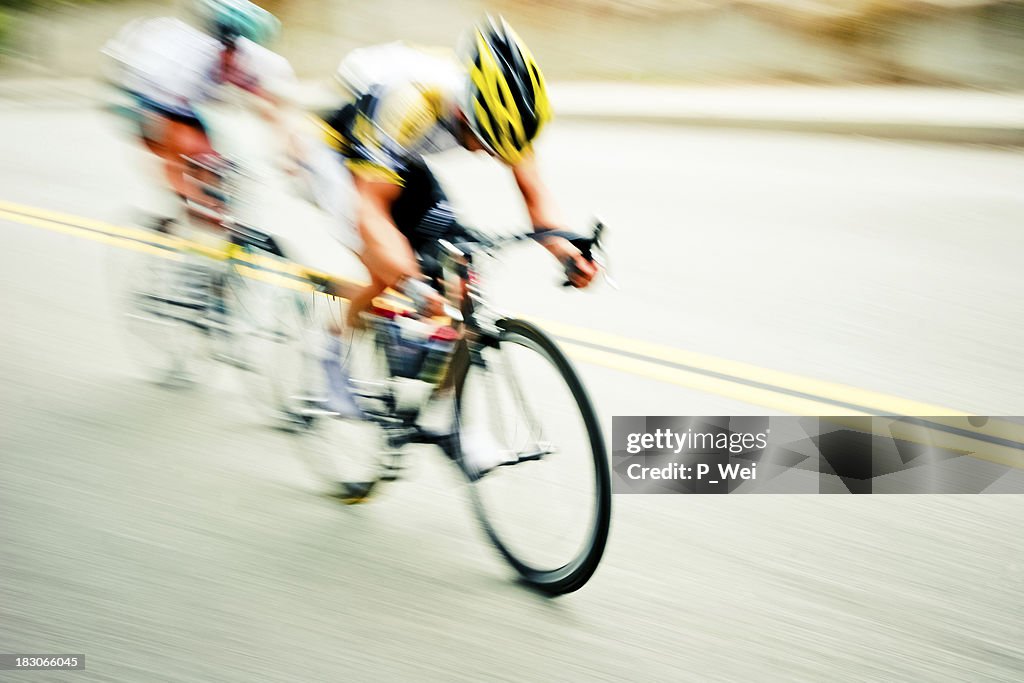 Speeding cyclists with abstract blur