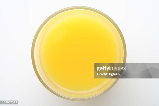 closeup of a top-angle glass of orange juice - orange juice stock pictures, royalty-free photos & images