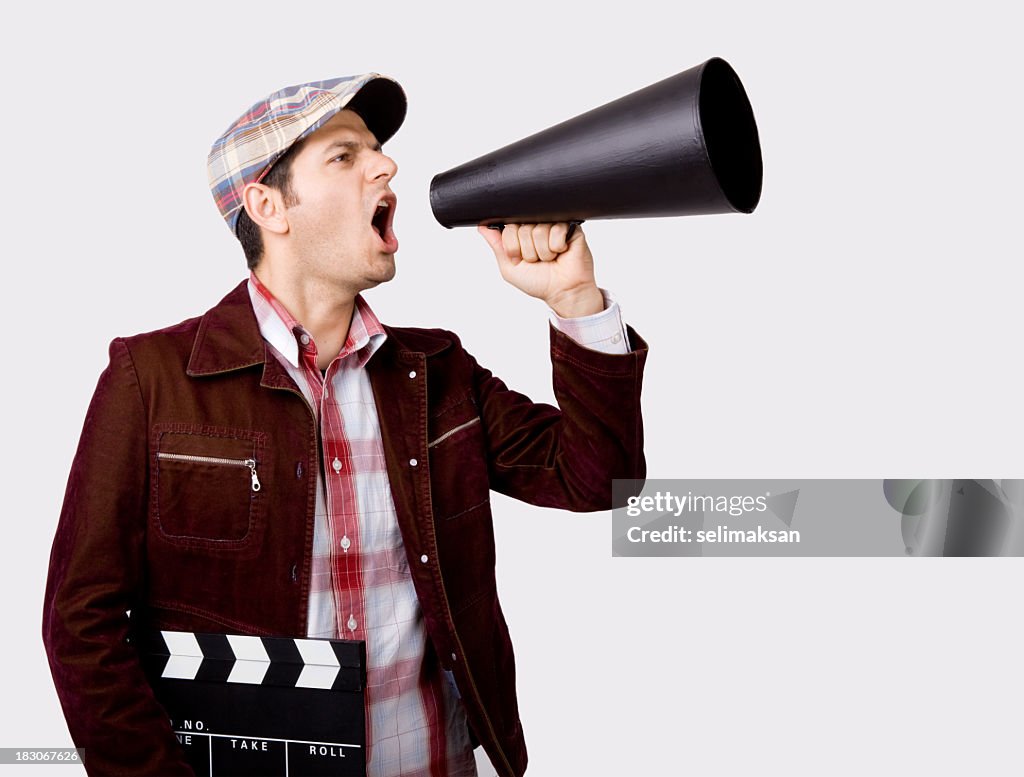 Film Director Shouting With Megaphone While Holding Film Slate