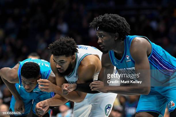 Brandon Miller of the Charlotte Hornets and Mark Williams of the Charlotte Hornets prepare to box out Karl-Anthony Towns of the Minnesota...