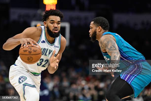 Karl-Anthony Towns of the Minnesota Timberwolves drives past Miles Bridges of the Charlotte Hornets during the second half of their game at Spectrum...