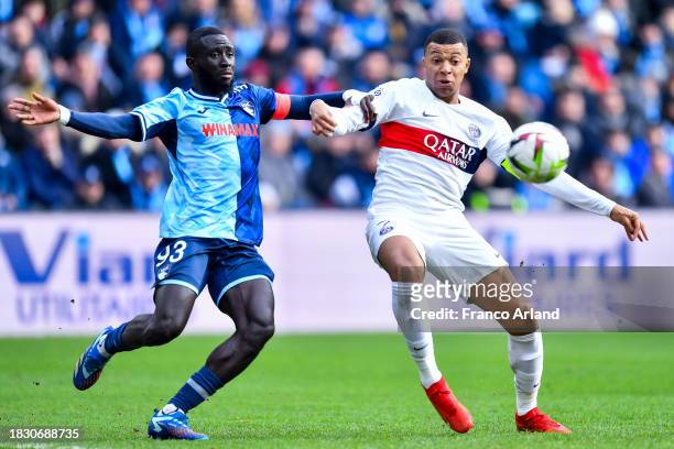 Arouna Sangante of Havre AC competes for the ball with Kylian Mbappe of PSG during the Ligue 1 Uber Eats match between Havre AC and Paris...