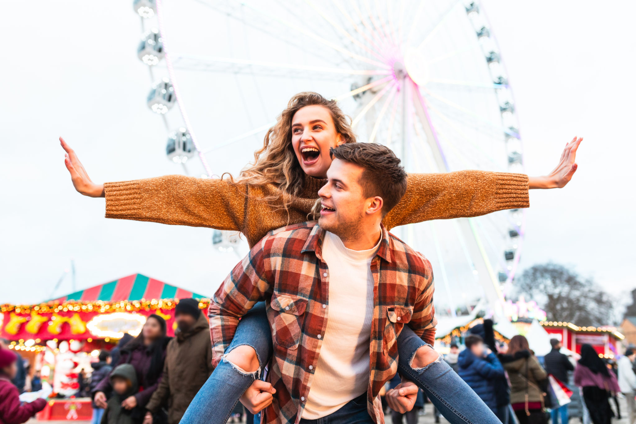 Happy couple having fun at amusement park in London Happy couple having fun at amusement park in London
