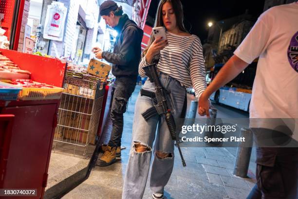 An armed woman walks through Jerusalem during increased tensions between Palestinians and Israelis on December 04, 2023 in Jerusalem. Gunmen, claimed...