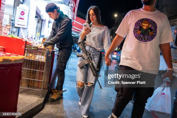 An armed woman walks through Jerusalem during increased tensions between Palestinians and Israelis on December 04, 2023 in Jerusalem. Gunmen, claimed...