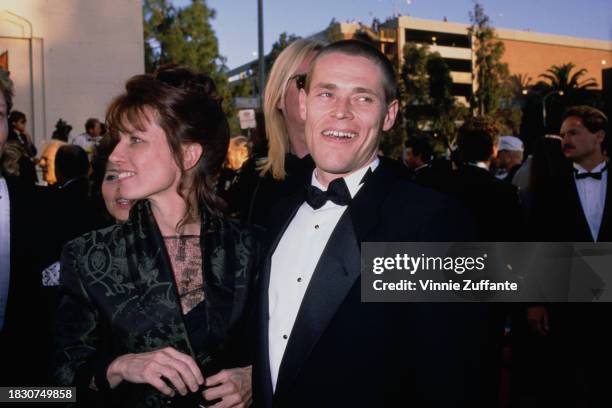 American theatre and dance director Elizabeth LeCompte and American actor Willem Dafoe, with his head shaved, attend the 61st Academy Awards, held at...