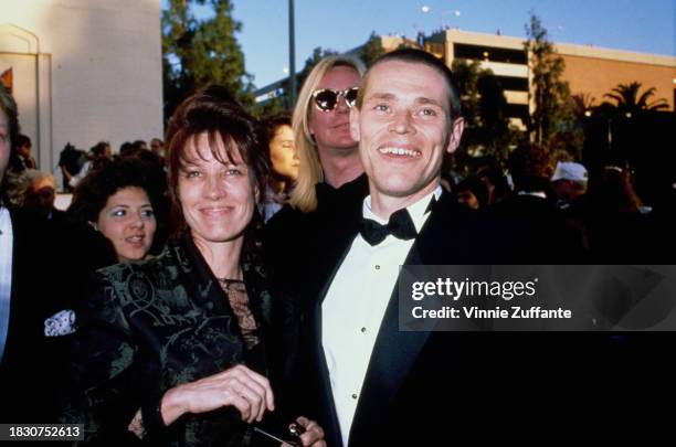 American theatre and dance director Elizabeth LeCompte and American actor Willem Dafoe, with his head shaved, attend the 61st Academy Awards, held at...