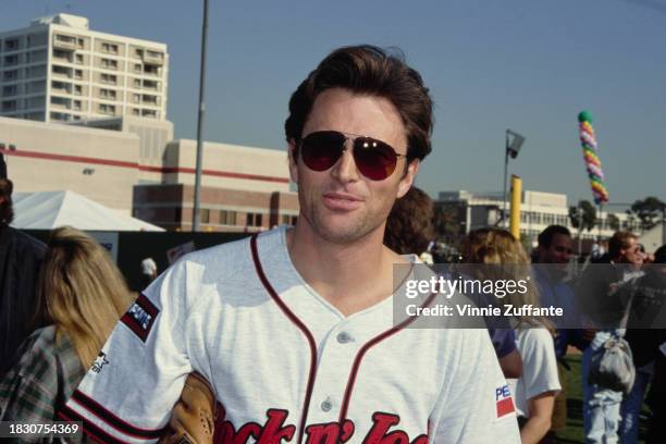 American actor Tim Daly, wearing the grey-and-red Awayboys kit, during MTV's 2nd Annual Rock N' Jock Softball Challenge, held at Dedeaux Field on the...