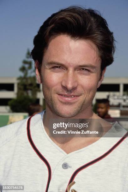 American actor Tim Daly, wearing the grey-and-red Awayboys kit, during MTV's 2nd Annual Rock N' Jock Softball Challenge, held at Dedeaux Field on the...