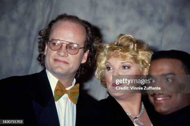 American actor Kelsey Grammer, wearing a black jacket over a white shirt with a paisley-patterned bow tie, American actress Tyne Daly, who has blond...