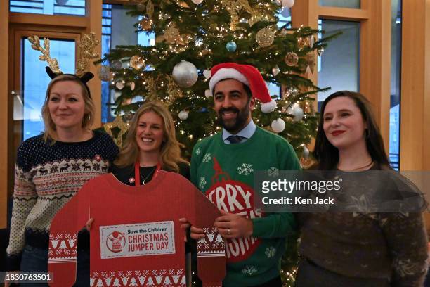 First Minister Humza Yousaf poses in a Christmas jumper in the lobby of the Scottish Parliament following First Minister's Questions, in support of...