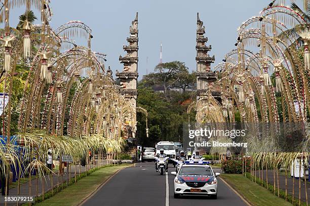 Police vehicles drive along a street near the Bali Nusa Dua Convention Center , venue for the Asia-Pacific Economic Cooperation summit, in Nusa Dua,...