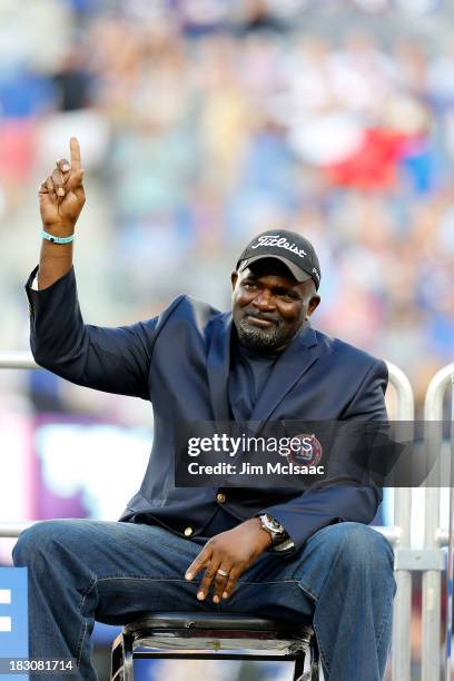 Former New York Giant Lawrence Taylor is introduced during a half time ceremony of a game between the New York Giants and the Denver Broncos honoring...