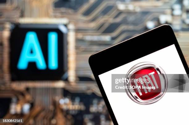 In this photo illustration, the Italian automobile manufacturer Fiat logo seen displayed on a smartphone with an Artificial intelligence chip and...