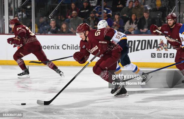 Troy Stecher of the Arizona Coyotes skates with the puck against the St Louis Blues at Mullett Arena on December 02, 2023 in Tempe, Arizona.