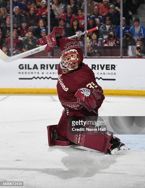 Connor Ingram of the Arizona Coyotes makes a blocker save against the St Louis Blues at Mullett Arena on December 02, 2023 in Tempe, Arizona.