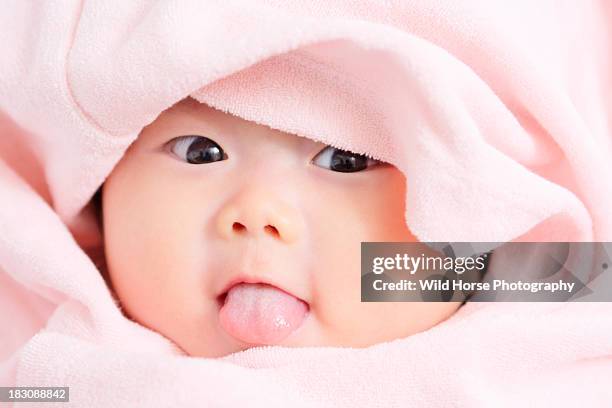 a little girl make faces (3 months old) - horse blanket stockfoto's en -beelden