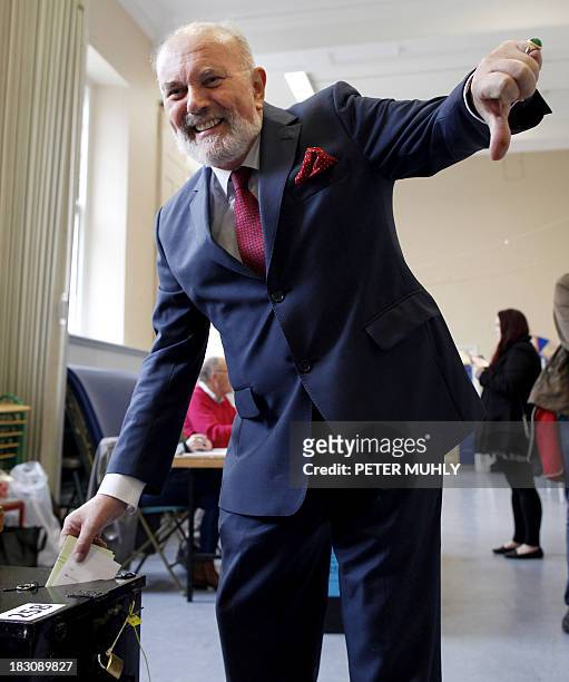 Irish Senator David Norris gives the thumbs-down sign as he casts his ballot during the Seanad referendum in Dublin, Ireland, on October 4, 2013....