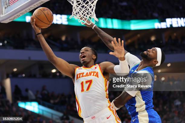 Onyeka Okongwu of the Atlanta Hawks drives to the basket against Bobby Portis of the Milwaukee Bucks during a game at Fiserv Forum on December 02,...