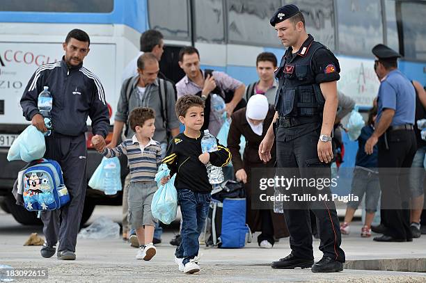 Immigrants board a ship bound for Porto Empedocle, Sicily on October 4, 2013 in Lampedusa, Italy. The search for bodies continues off the coast of...