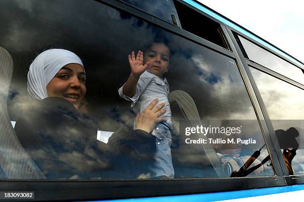 Immigrants wait to board a ship bound for Porto Empedocle, Sicily on October 4, 2013 in Lampedusa, Italy. The search for bodies continues off the...