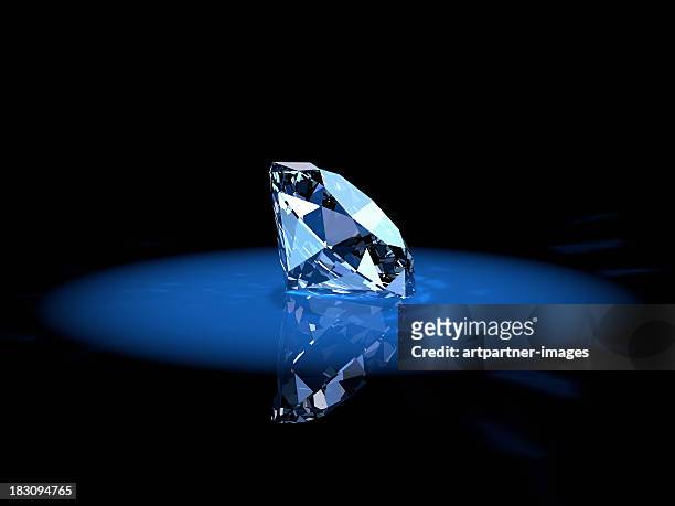 shiny diamond gem in a blue spotlight - diamond stockfoto's en -beelden